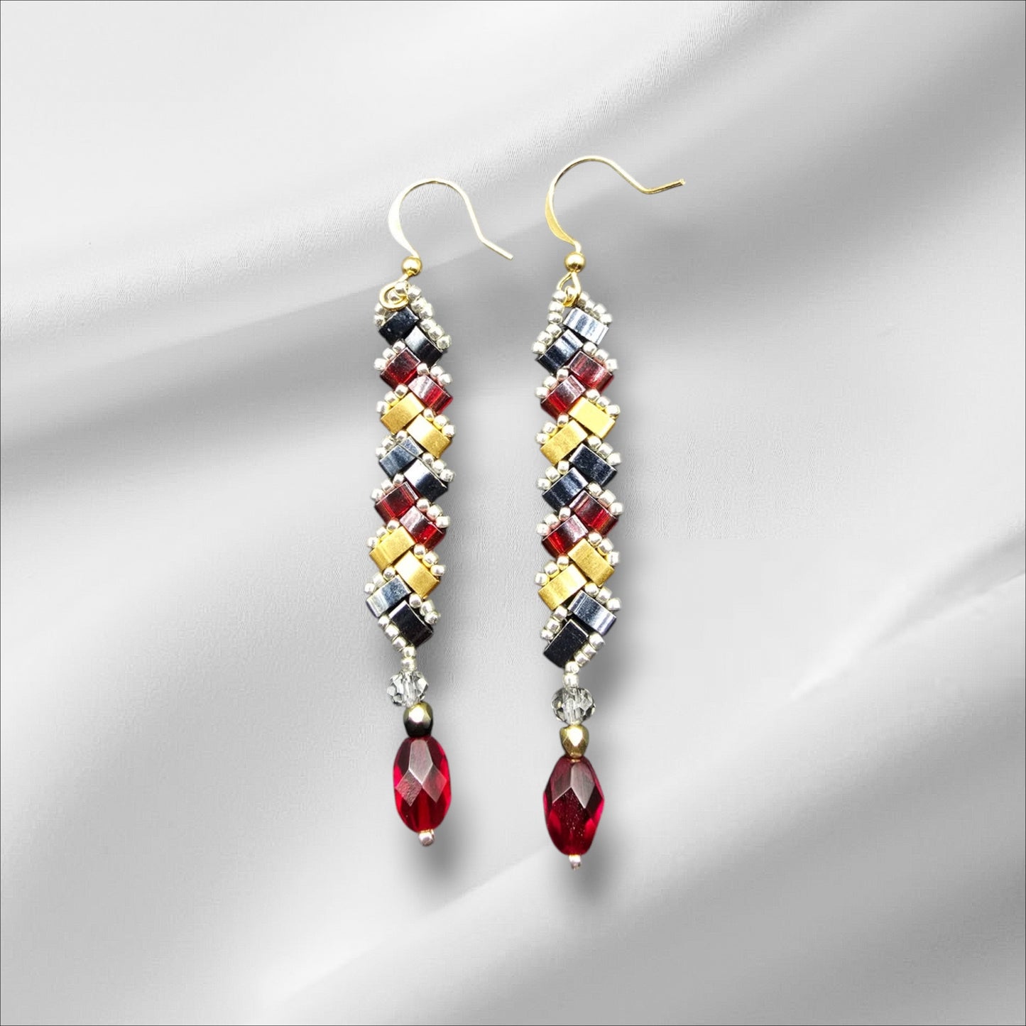 a pair of red, yellow, and black beaded earrings