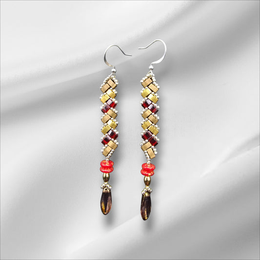 a pair of earrings on a white background
