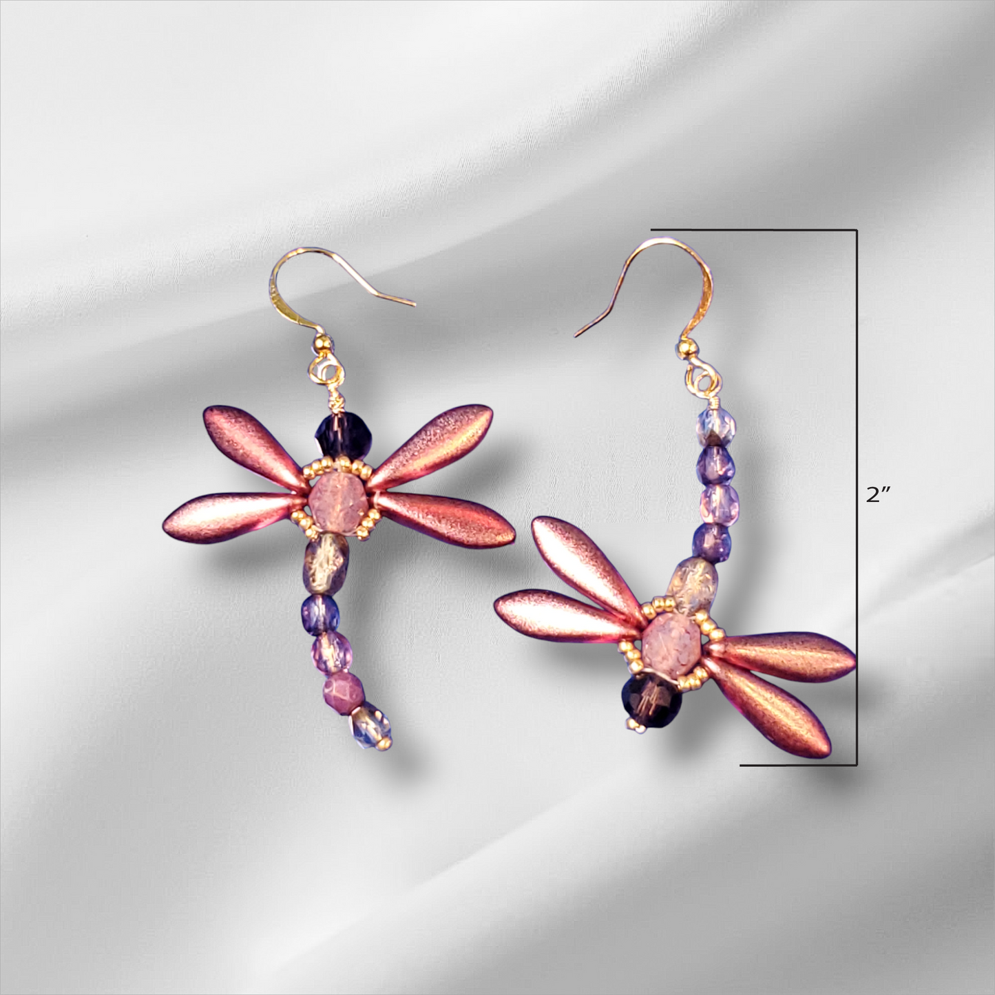 a pair of earrings with flowers and beads