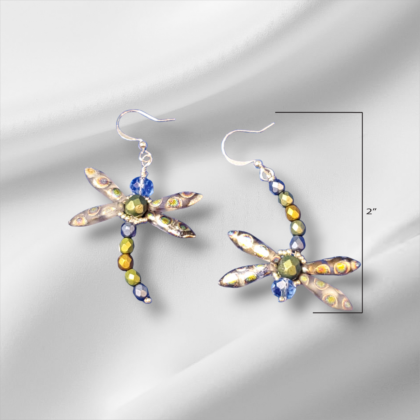 a pair of dragonfly earrings with multicolored beads