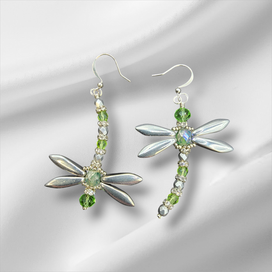 a pair of earrings with green and white stones