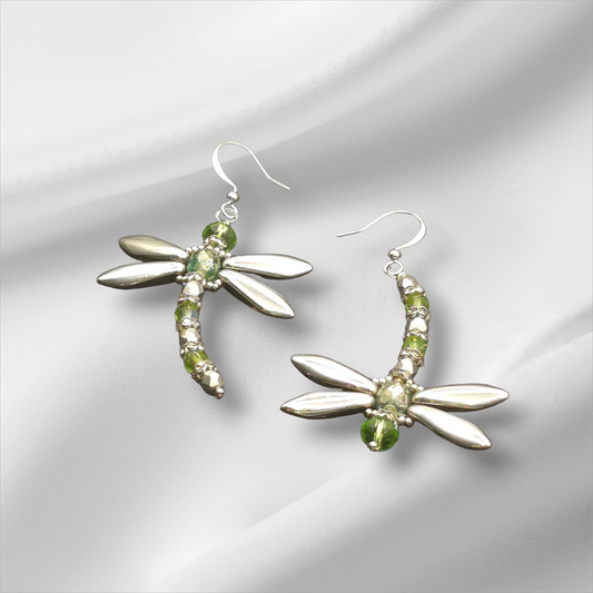 a pair of silver earrings with green stones