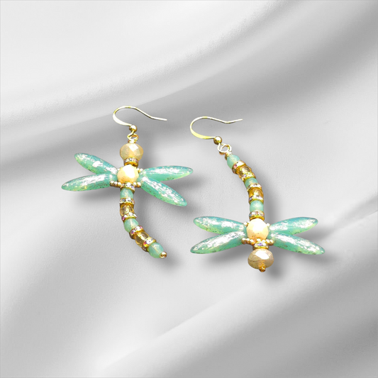 a pair of green and gold dragonfly earrings