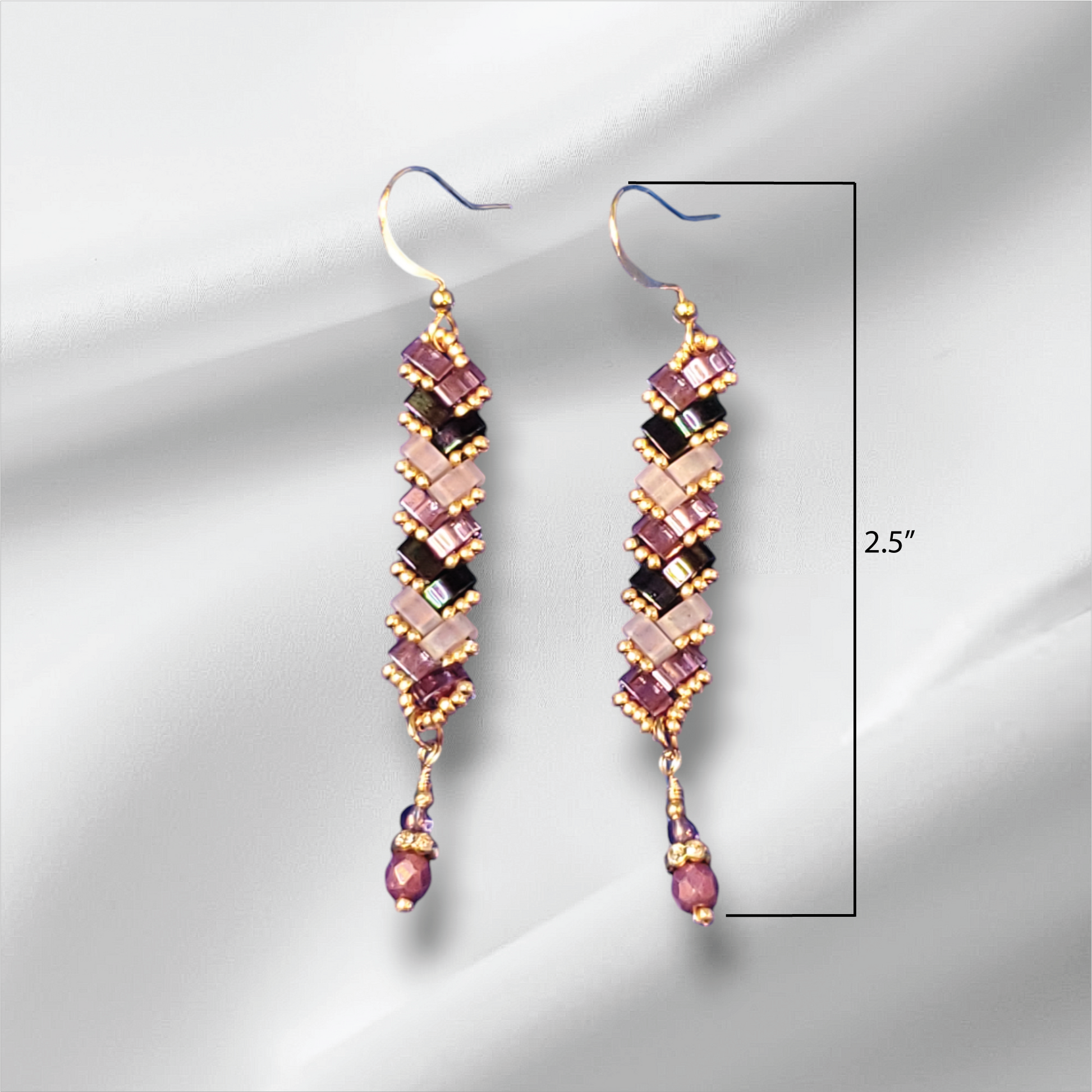 a pair of pink and black beaded earrings