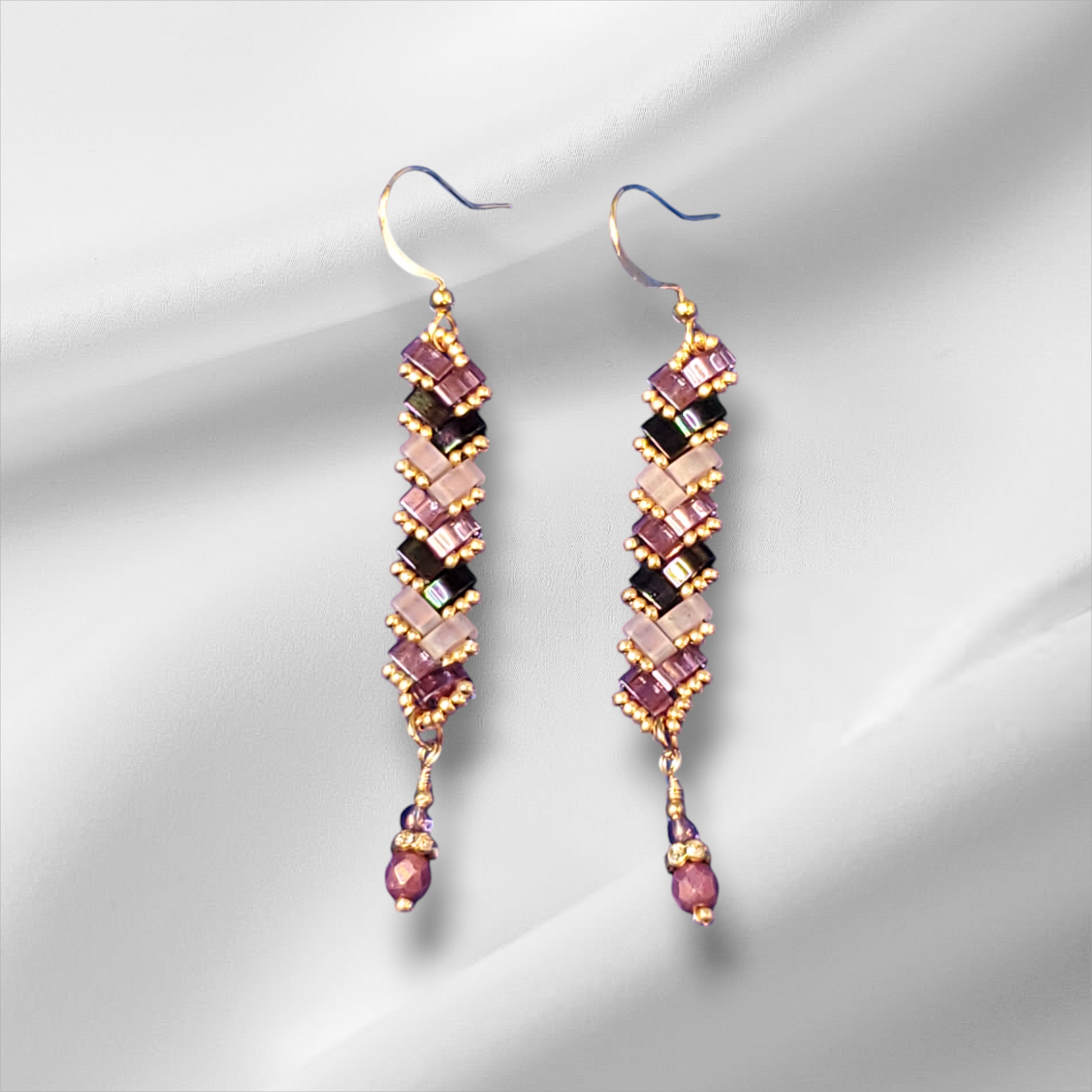 a pair of pink and black beaded earrings