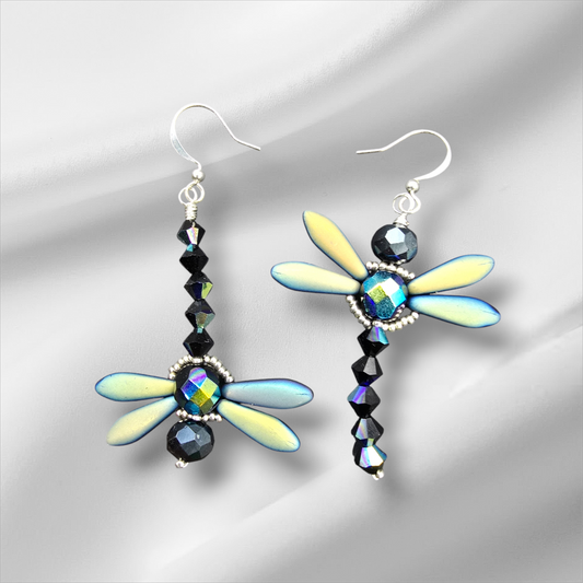 a pair of earrings with a dragonfly design