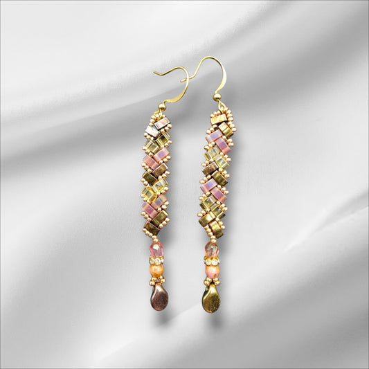 a pair of earrings on a white background