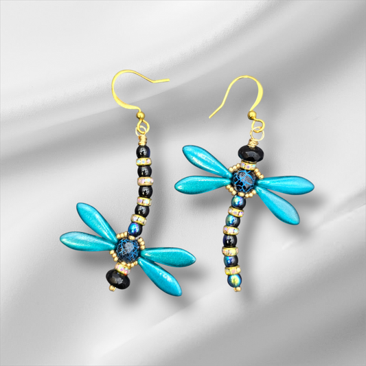 a pair of blue and black dragonfly earrings