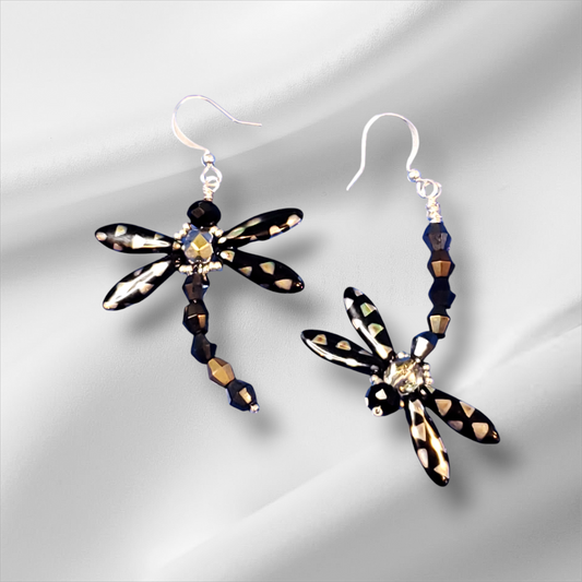 a pair of black and white dragonfly earrings